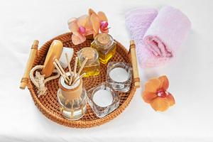 Spa wellness items with fragrant oil and orchid on white, a Beauty & Fashion Photo by Olena Rudo