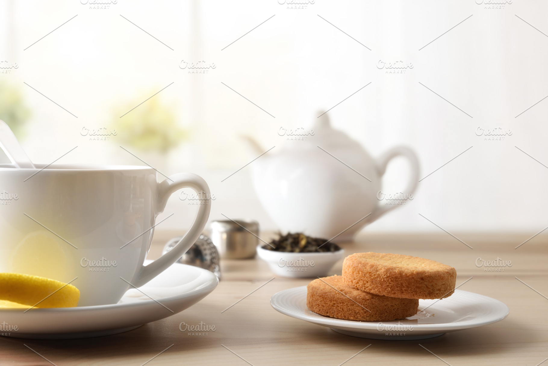 Tea cakes on wooden table with a cup and teapot, a Food & Drink Photo by Davizro's Market