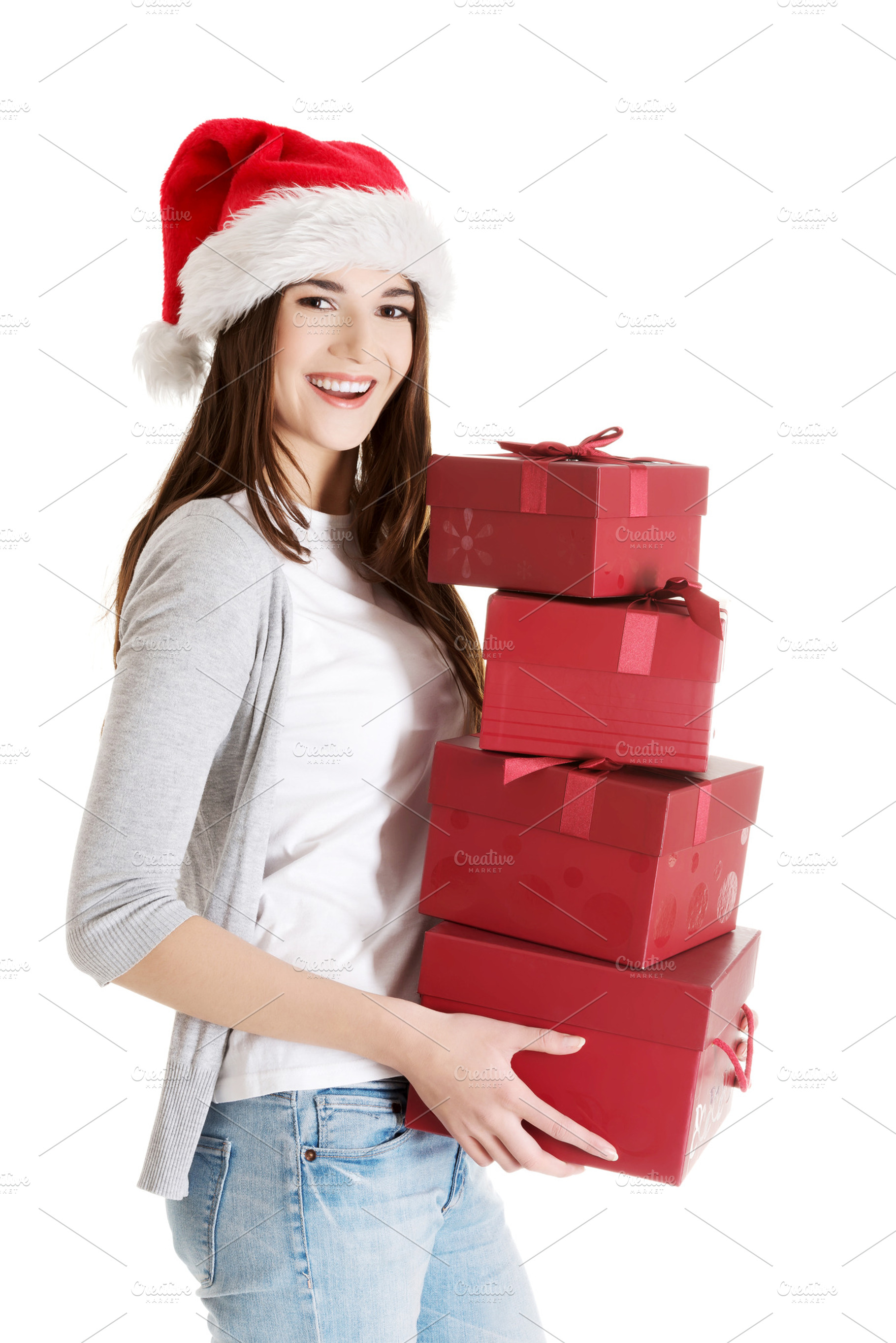 Beautiful woman in santa hat holding presents., a Person Photo by PhotoMediaGroup