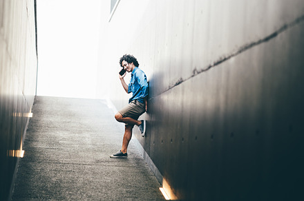 Young man chatting on phone outdoors, a Person Photo by SkyNext