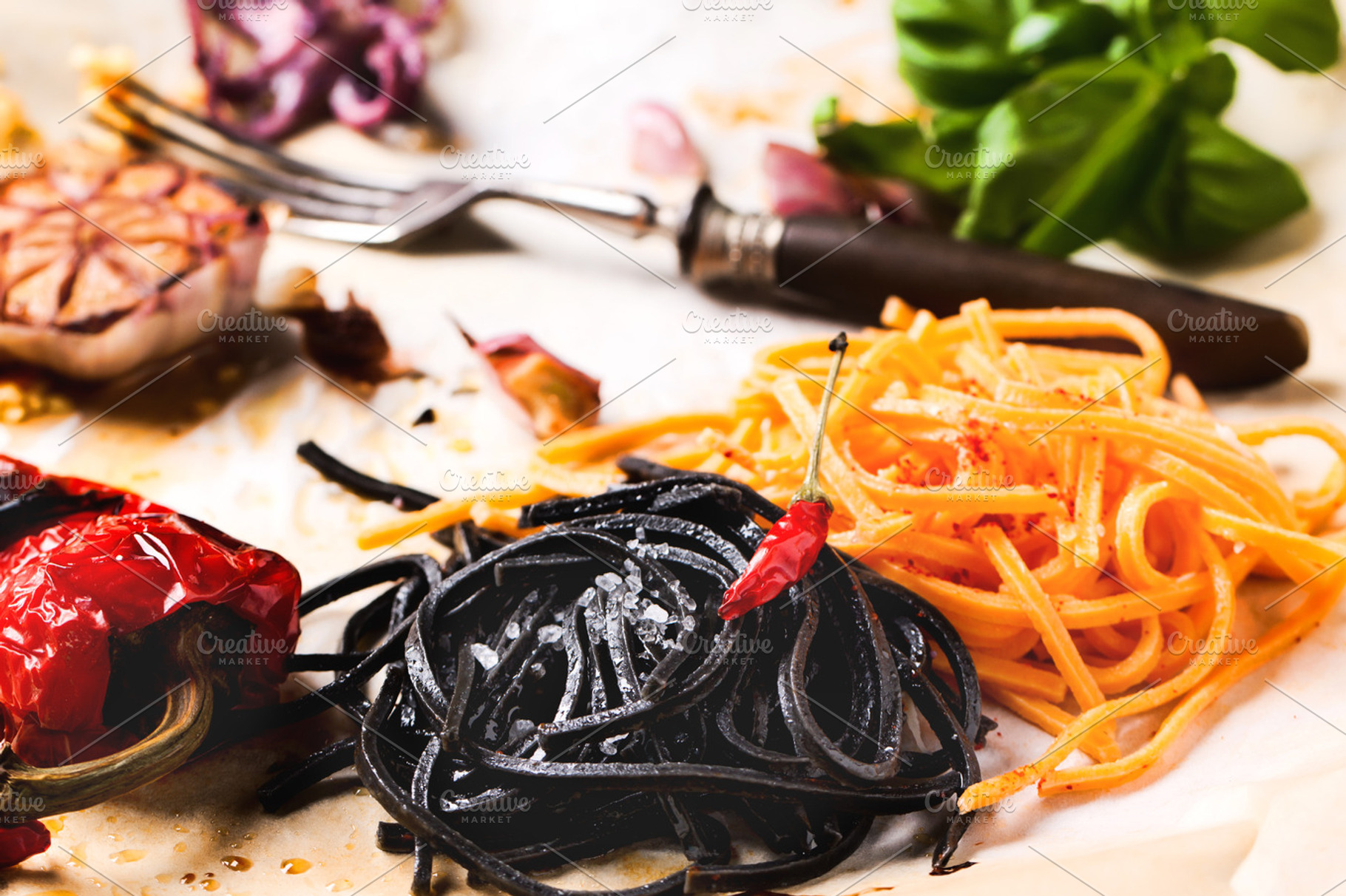 Black and orange spaghetti containing pasta, italian, and food
