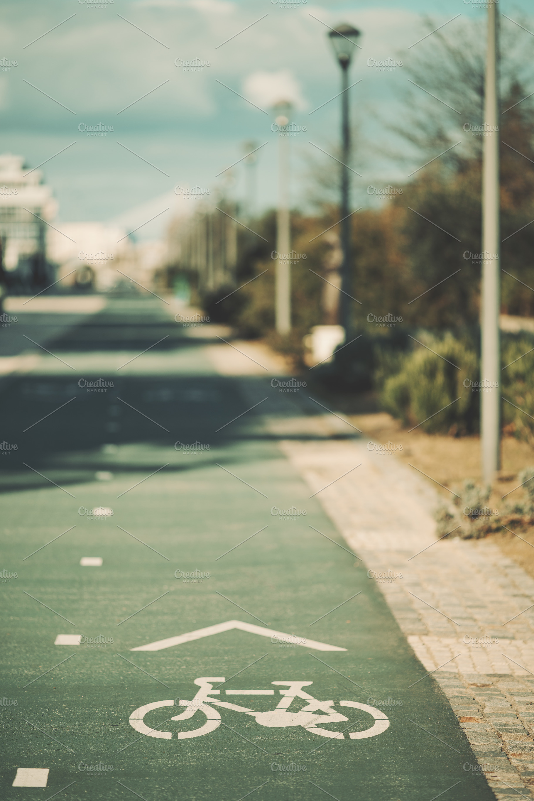 Bike lane symbol on empty city path, an Industrial Photo by SkyNext