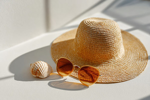Straw hat, sunglasses and seashell in sunlight, a Beauty & Fashion Photo by AlyaAnd
