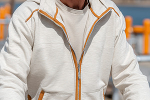 Mature man in beige tracksuit using, a Photo by Pixeness Studio