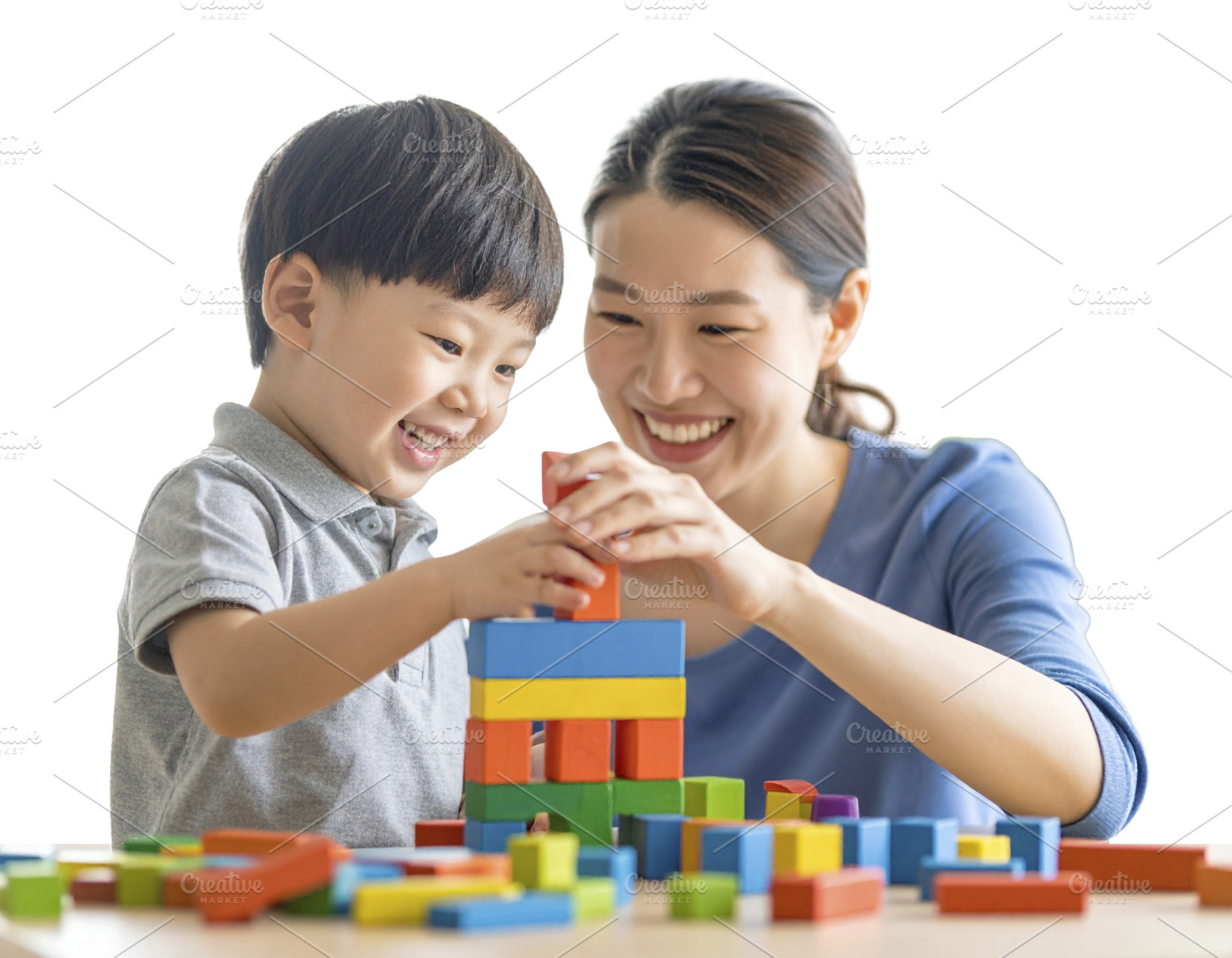 Child and mother building with blocks isolated photo, a School & Education Photo by DanFLCreativo