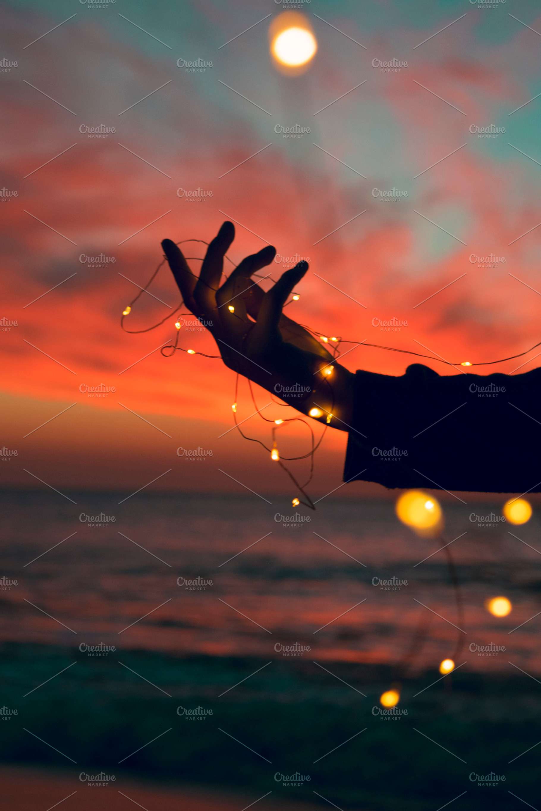 Hand holding lights, a Nature Photo by Fossilized Tree Sap