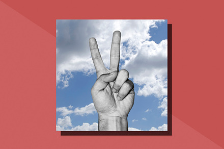 Hand with victory sign, a Photo by Psychopicture