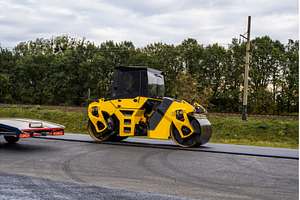 Heavy asphalt road roller that press, an Industrial Photo by volodymyrshtun13795