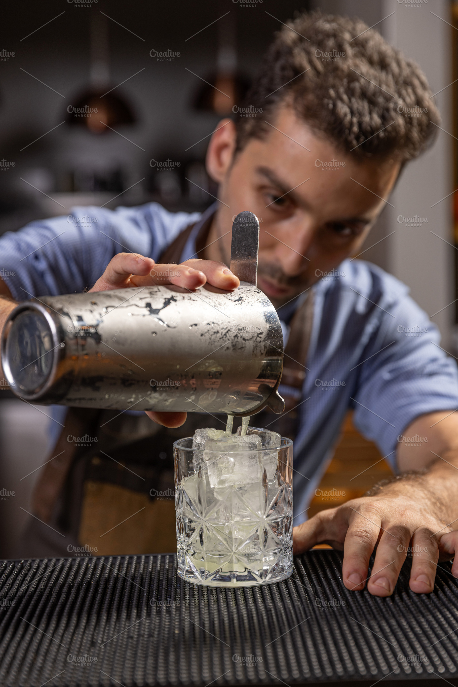 Bartender pouring ingredients, a Photo by Grafvision photography
