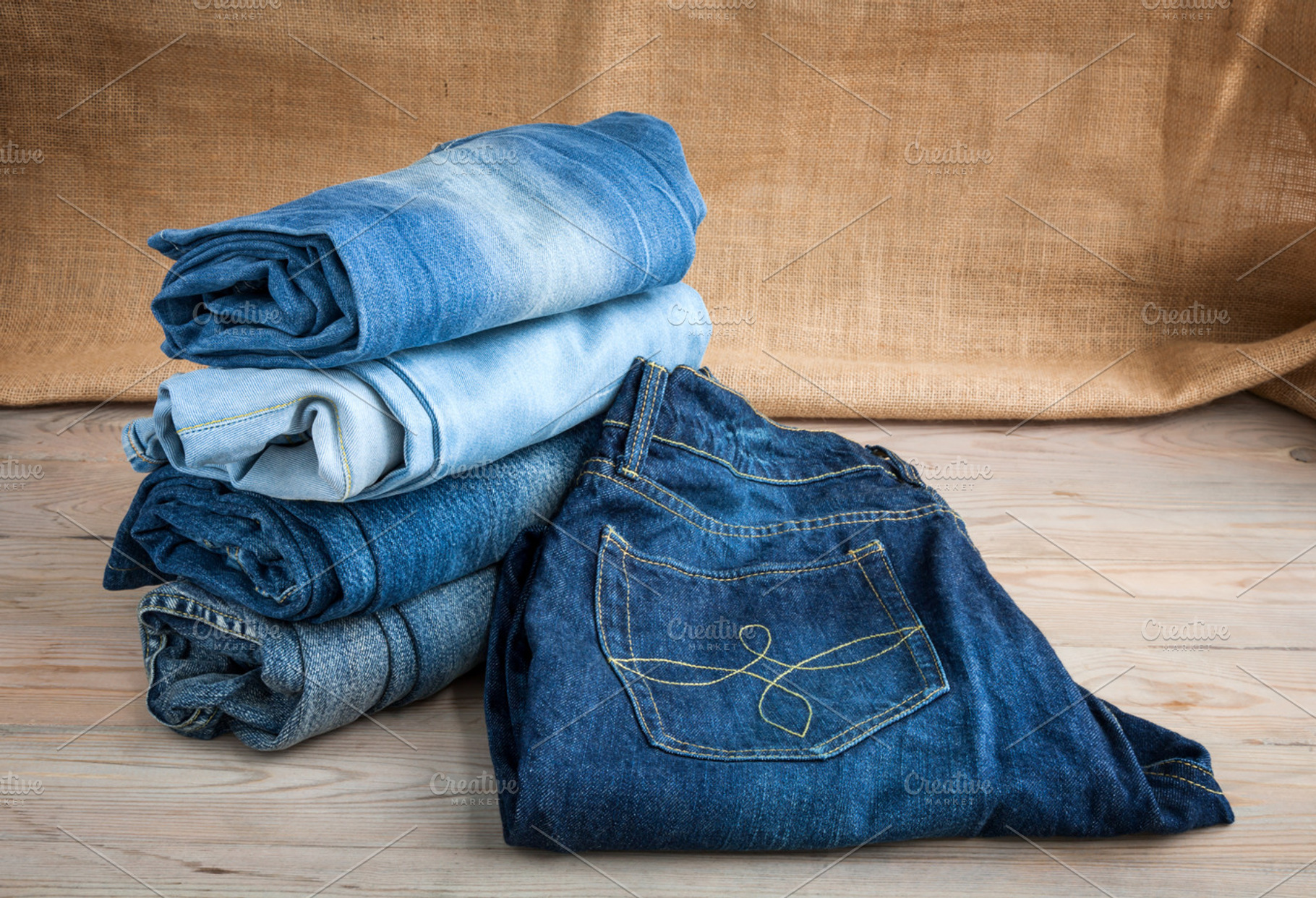 Blue jeans on wooden table featuring blue jeans, pants, and broken legs