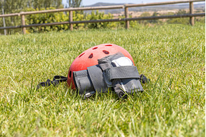 A red helmet and A gray wrist guard