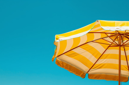 Yellow Striped Beach Umbrella Against Blue Sky, an Abstract Photo by Natalia Klenova's Shop