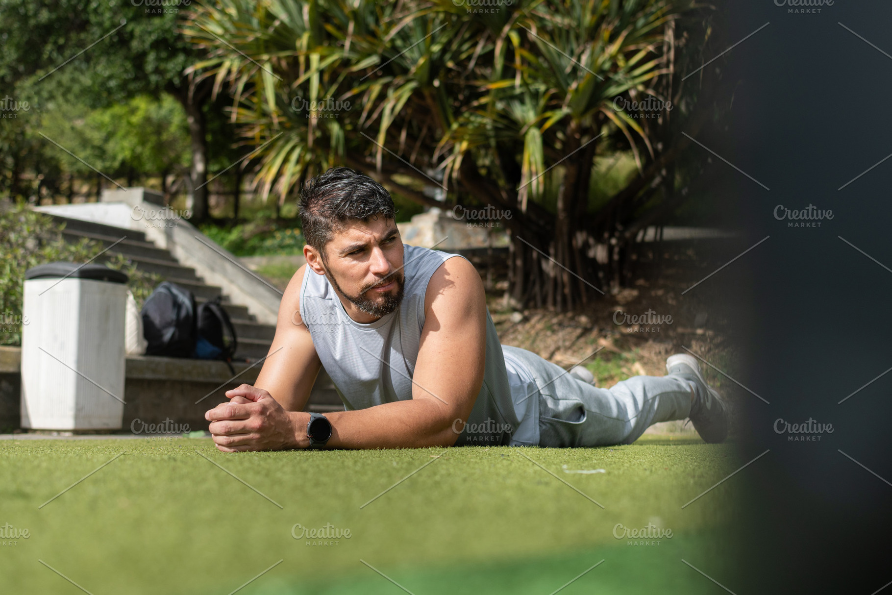 Young man resting after workout lying on grass in park, fitness recovery concep, a Sports & Recreation Photo by etorres69
