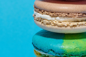 Multicolored macarons on a blue background, a Food & Drink Photo by ndanko
