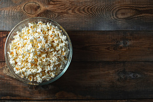 Popcorn on wood color background.Food and snack concepts ideas.Minimal style to, a Food & Drink Photo by Budarinphoto