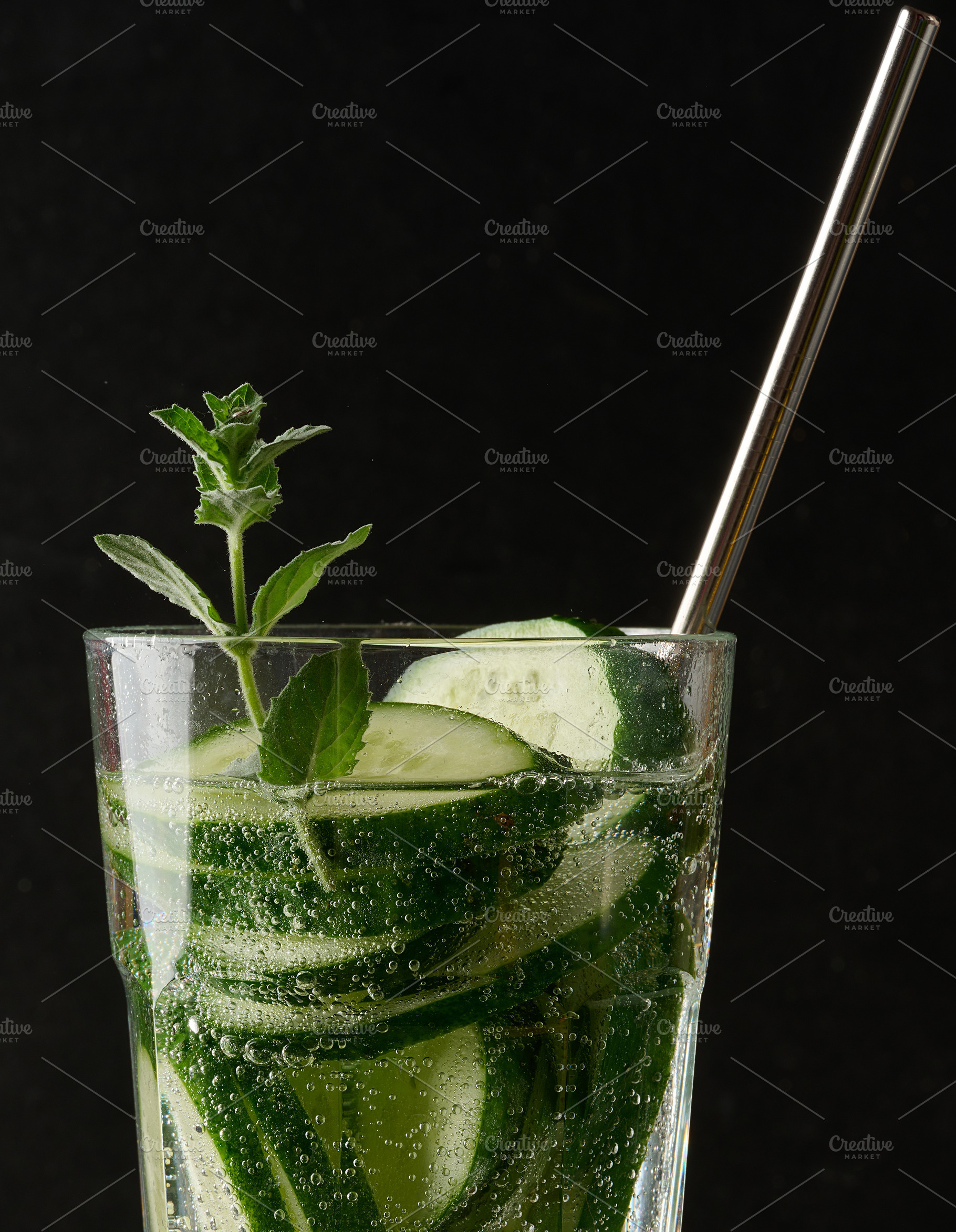 A glass of refreshing detox water with slices of cucumber and a, a Food & Drink Photo by ndanko