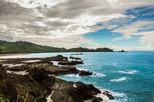 Rocky Coastline with isle & blue sea