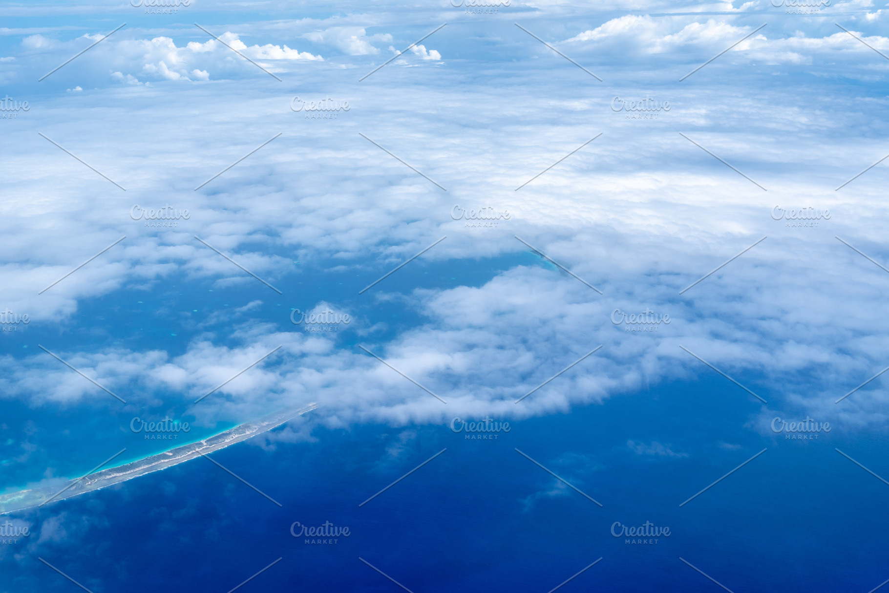 Aerial view of the Tuamotus atoll in French Polynesia with cloud, a Nature Photo by GoodGoods