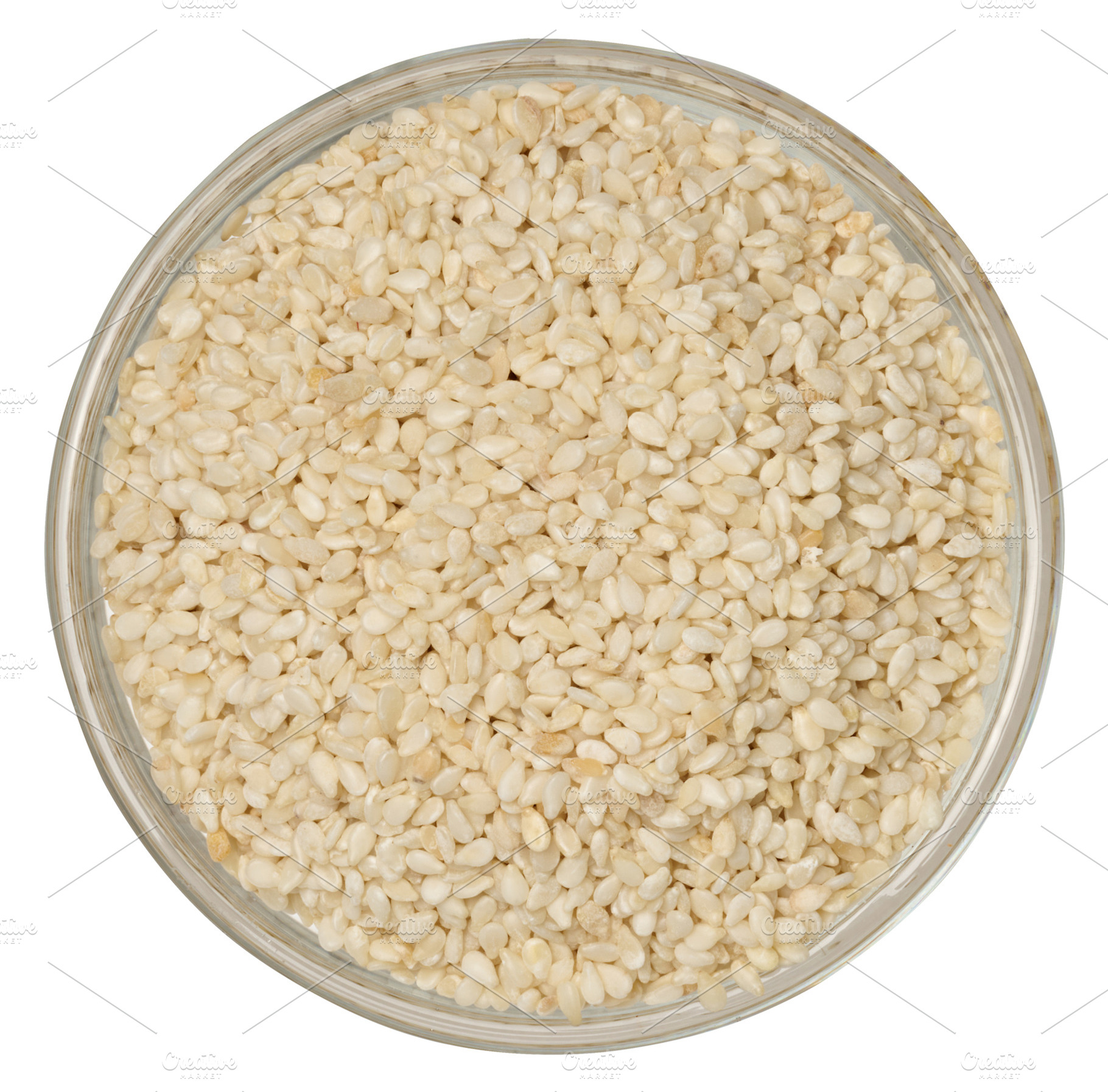 White sesame seeds in a round glass bowl on an isolated backgrou, a Food & Drink Photo by ndanko