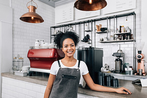 Young smiling woman with curly hair, a Business Photo by Artem Varnitsin