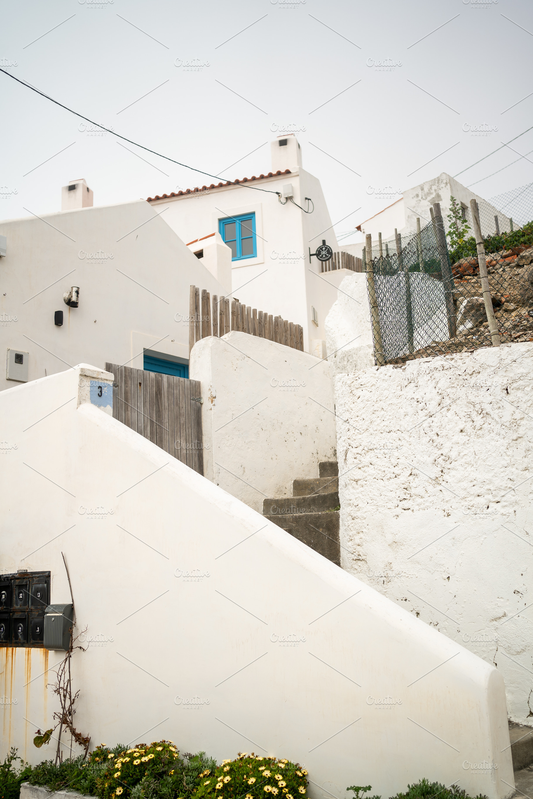 From below of white houses and steps in small town of Portugal, a Photo by andreonegin market