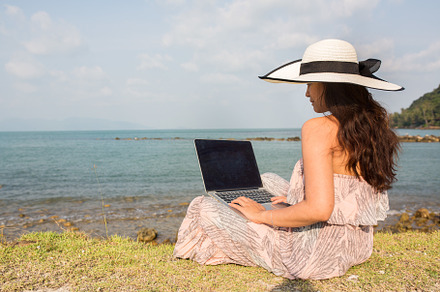 Woman working on Laptop by the beach, a Person Photo by Beach Babe Stock