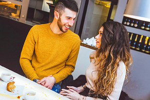 Young couple holding hands and talking in a cafe, a Person Photo by Antonio Gravante Market