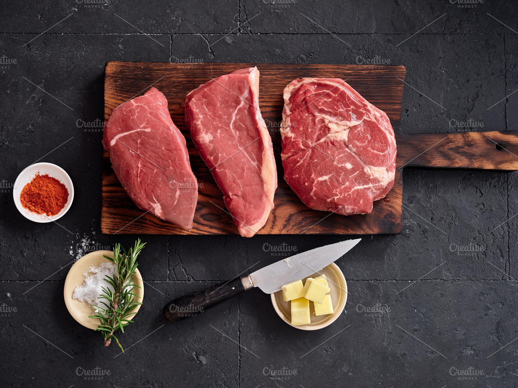 Raw rib-eye, roast beef, flank, and rump steak displayed on a wooden cutting bo, a Food & Drink Photo by Asya Nurullina