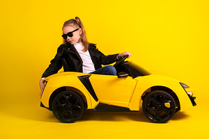 Confident young girl in sunglasses and leather jacket poses in a, a Person Photo by Ales Munt