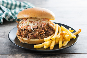 Pulled pork sandwich with coleslaw salad and french fries on woo, a Food & Drink Photo by etorres69