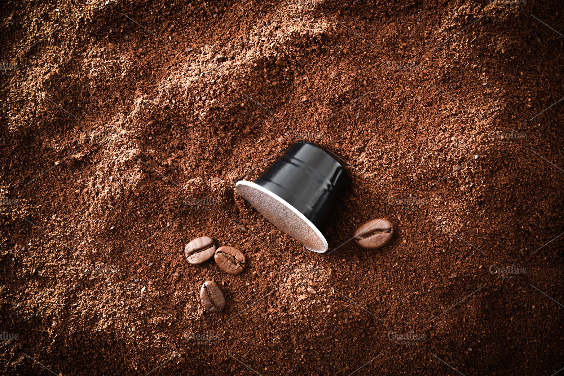 Espresso capsules on pile of coffee beans and isolated backgroun, a Food & Drink Photo by Davizro's Market