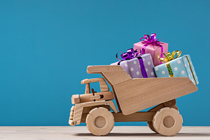 Gift boxes on dumper truck featuring car, gifts, and holidays