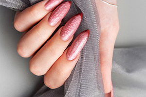 Woman's hand showing stylish textured pink stiletto nails, a Beauty & Fashion Photo by Olena Rudo