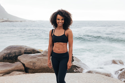 Smiling woman in fitness wear posing, a Sports & Recreation Photo by Artem Varnitsin