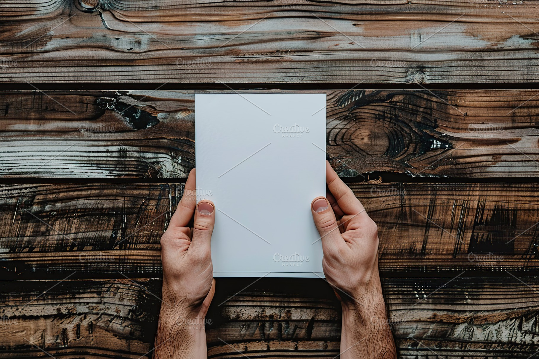 Male hands with blank sheet of paper on wooden background, a Background Photo by AlyaAnd