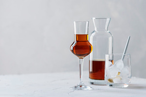 A shot of a strong ligueur with ice featuring selective focus, copy space