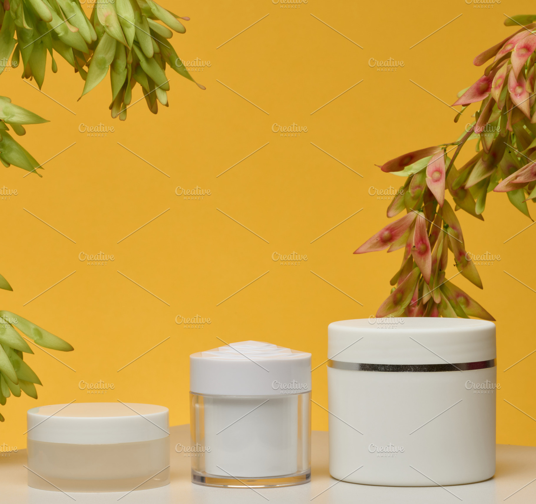 Three white cosmetic jars without labels stand on a white backgr, a Food & Drink Photo by ndanko