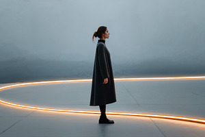 Creative portrait of a woman standing in a modern space with light, a Person Photo by OSORIOartist