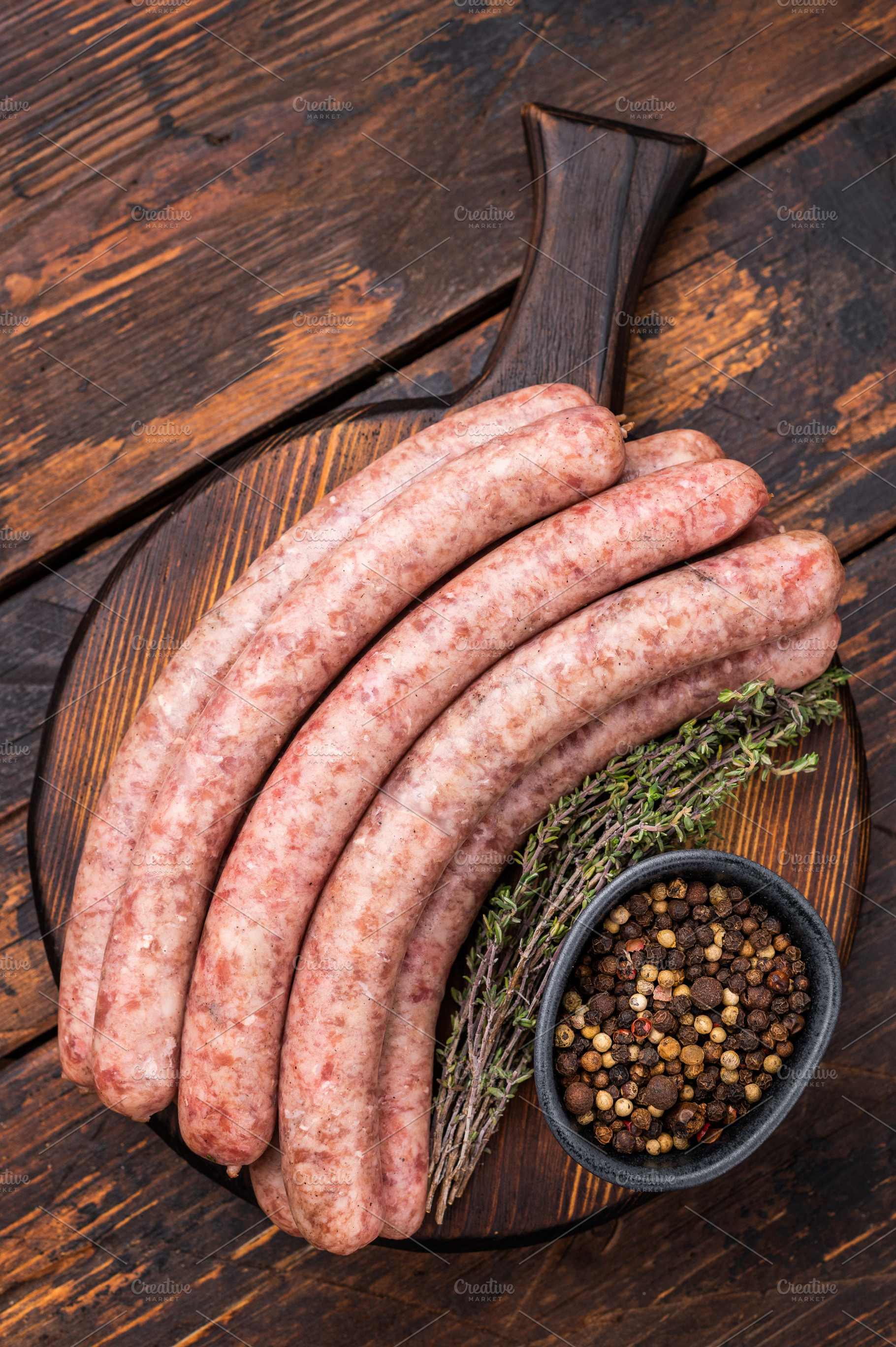 Uncooked sausage on a wooden board, a must have ingredient for d, a Food & Drink Photo by composter-box@mail.ru