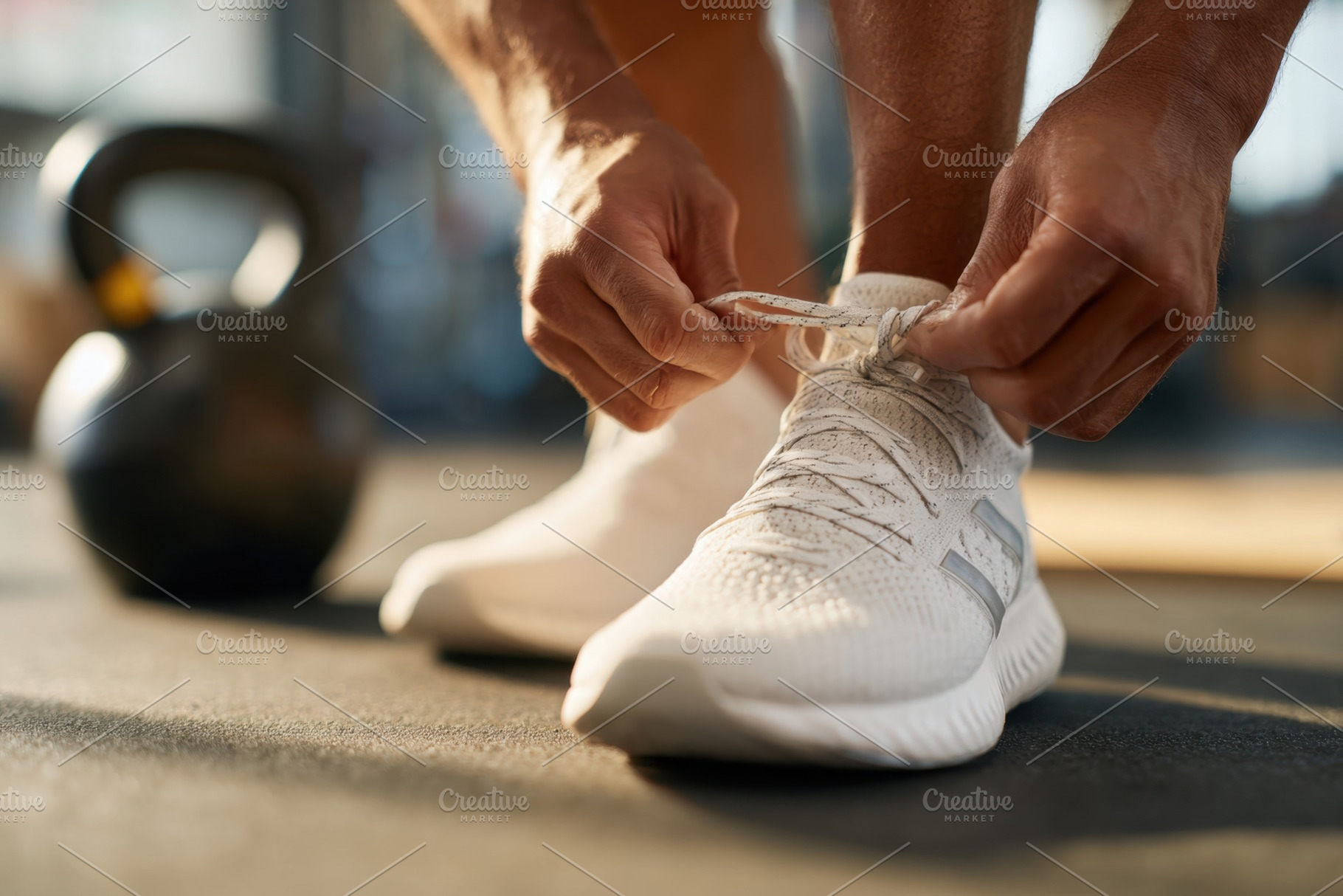 Tying shoelaces on athletic shoes in gym, a Sports & Recreation Photo by AlyaAnd