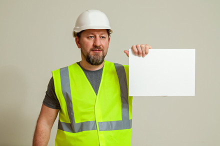 worker in a vest and white helmet, a Person Photo by Photostock