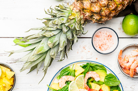 Fresh pineapple salad with shrimps, spinach, avocado and lime on, a Food & Drink Photo by 5PH