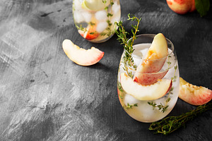 Peach lemonade with thyme on a dark stock photo containing peach and lemonade, a Food & Drink Photo by matucha