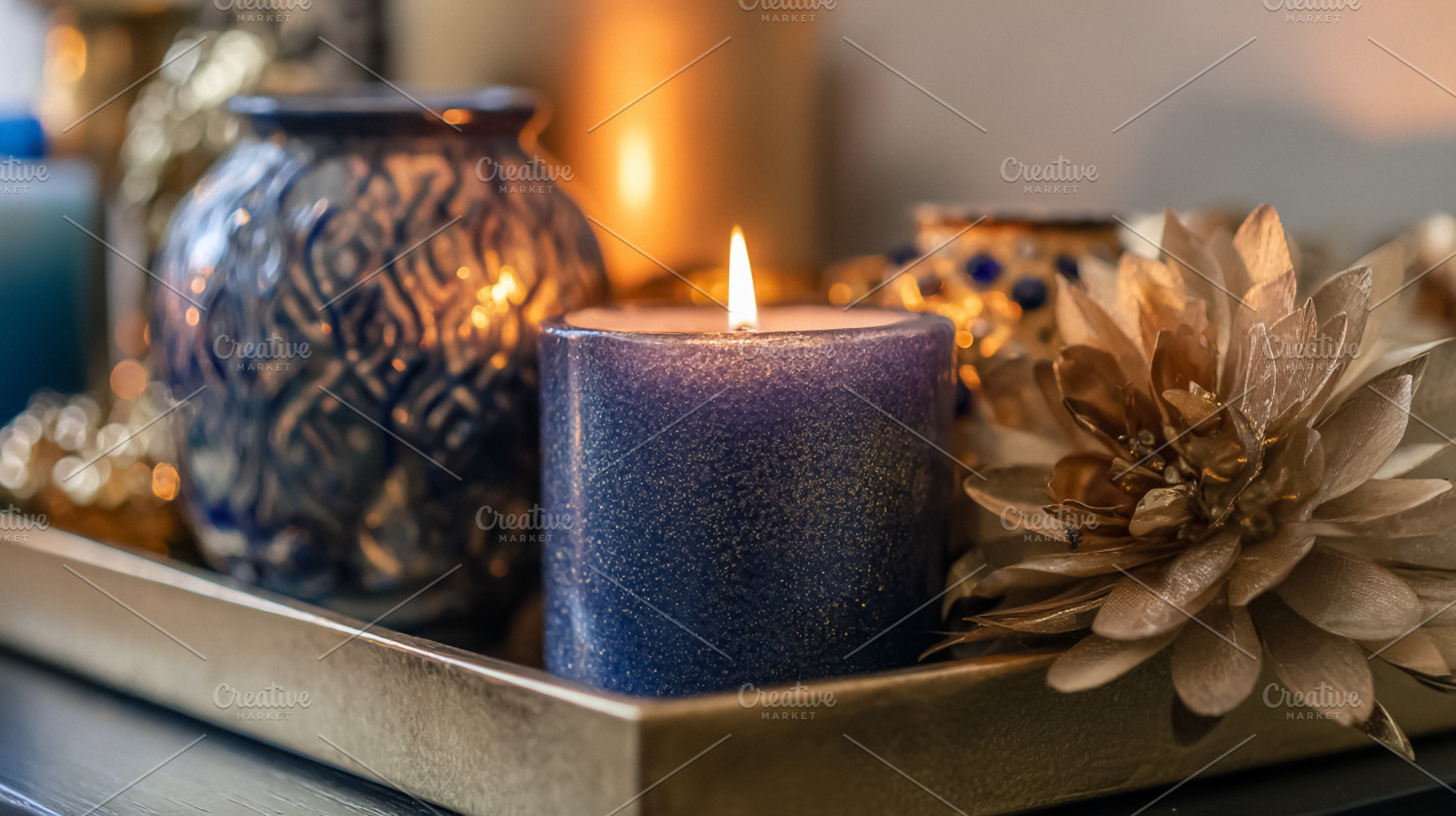 Burning indigo glitter candle creating hygge atmosphere with shi, a Photo by Studio ANNA