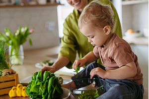 Mom and little boy preparing lettuce, a Food & Drink Photo by HalfPoint