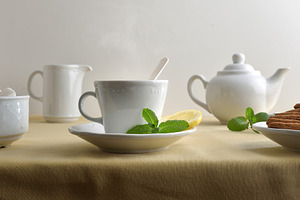 White ceramic tea set on a table with a tablecloth, a Food & Drink Photo by Davizro's Market