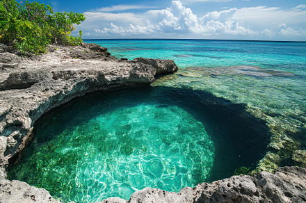 Bright blue water in a serene natura, a Photo by Iftikhar Alam