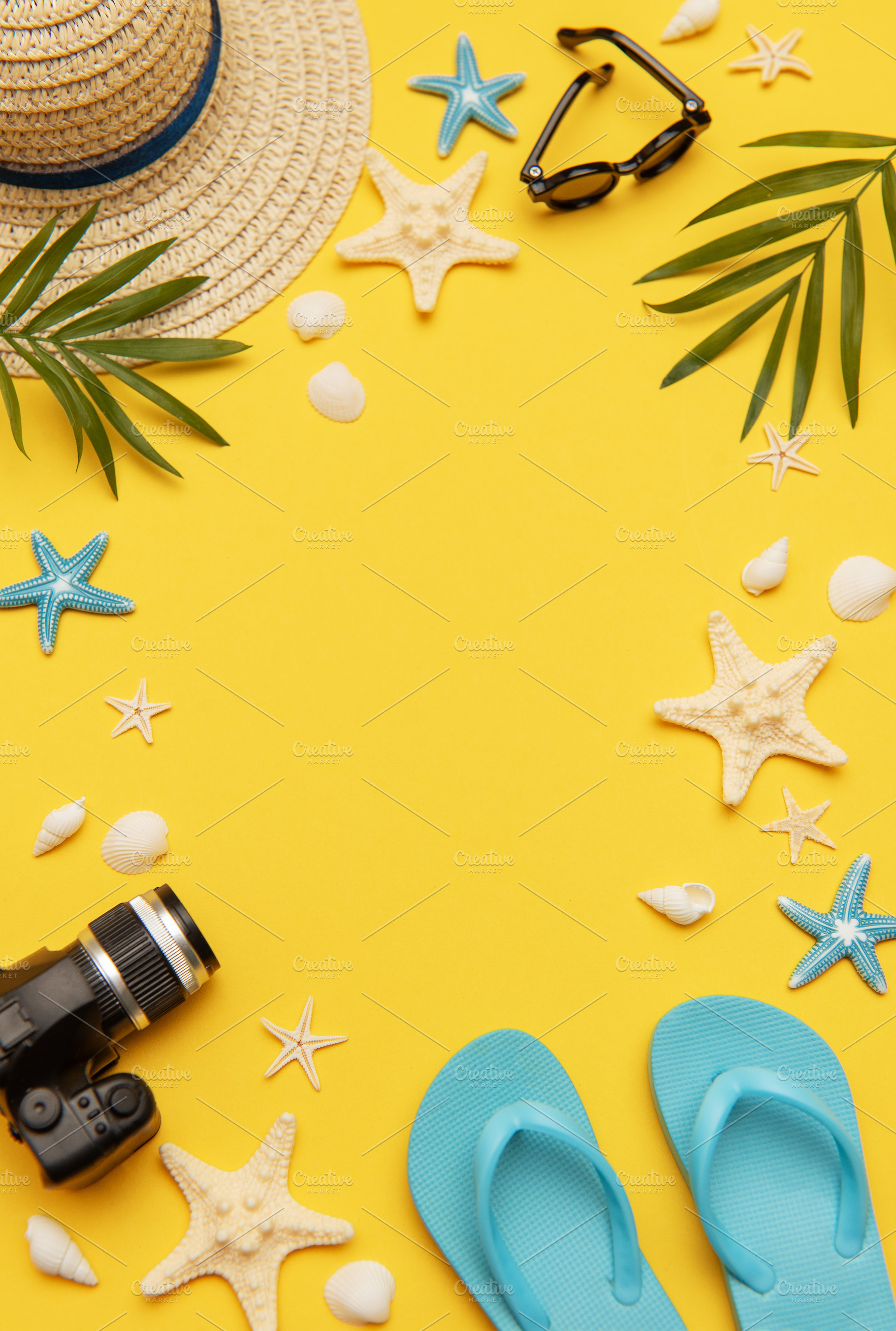 Summer accessories framing vibrant yellow background for travel, a Holiday Photo by Olena Rudo