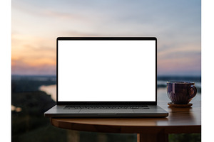 Laptop blank screen mockup at sunset, a Technology Photo by Fascinadora