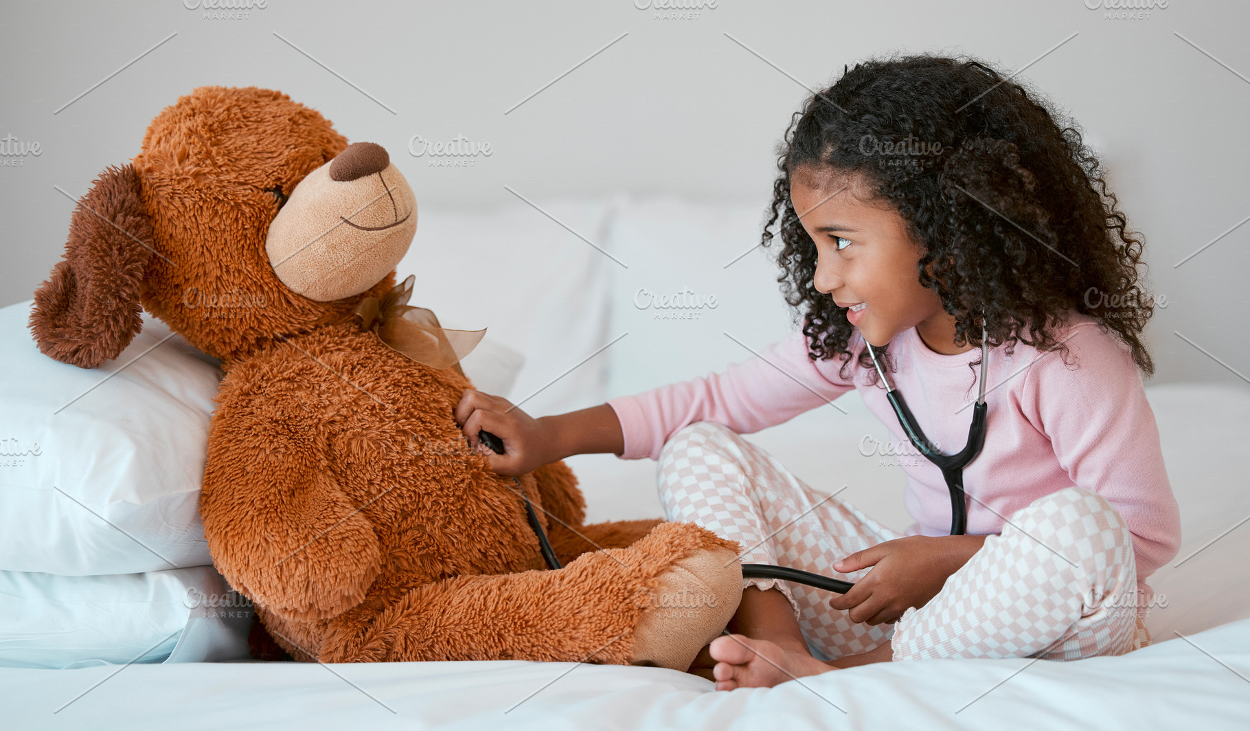 Teddy bear, learning and child with stethoscope for healthcare, heart and anatomy education in her bedroom and home for development. Girl play with hospital, doctor or nurse cardiology toys or tools, a Photo by Peopleimages.com